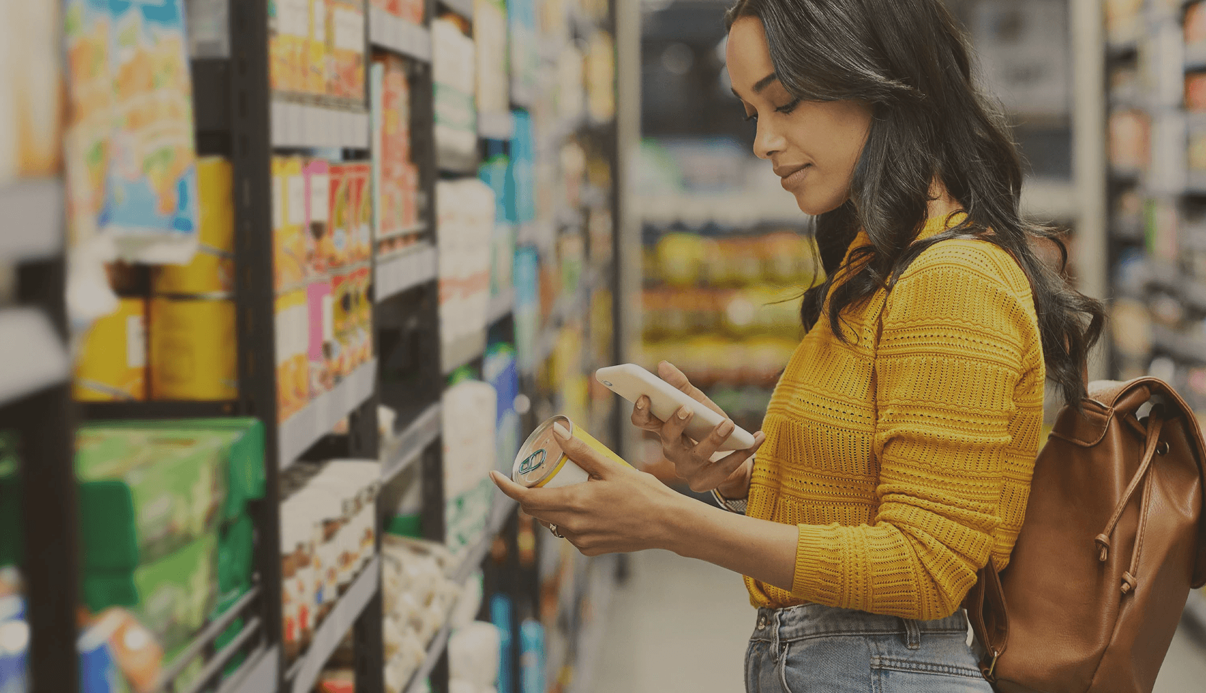 Woman shopping with basket at grocery store